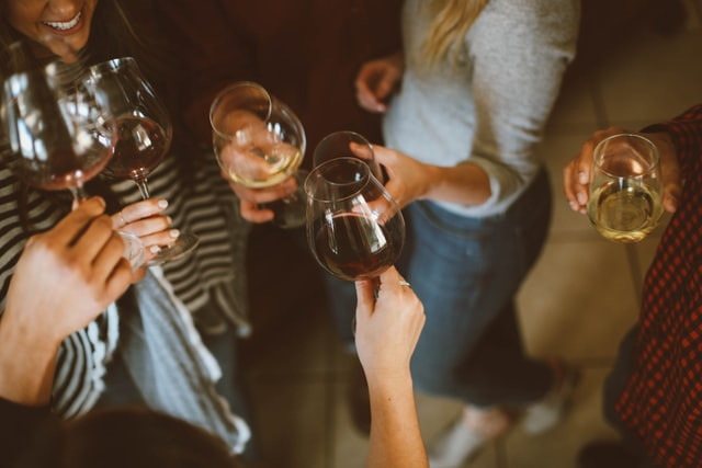 Group of people clinking glasses of wine